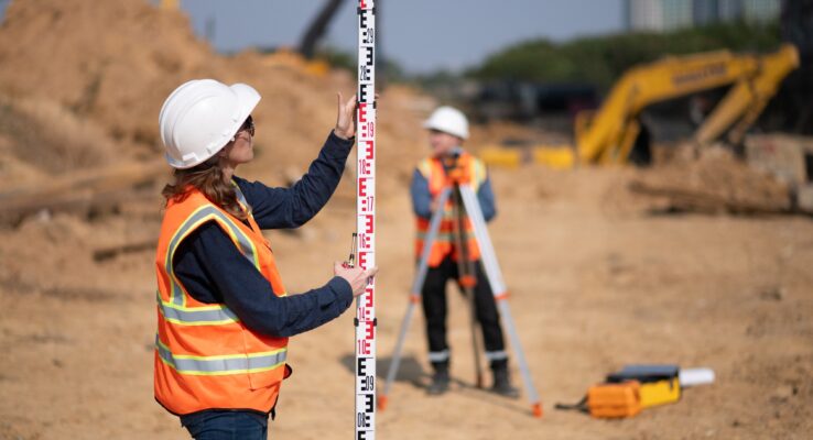 Why Choosing a Local Construction Company in Abu Dhabi Adds Value 1 Construction surveyor or engineer working in pipe construction site