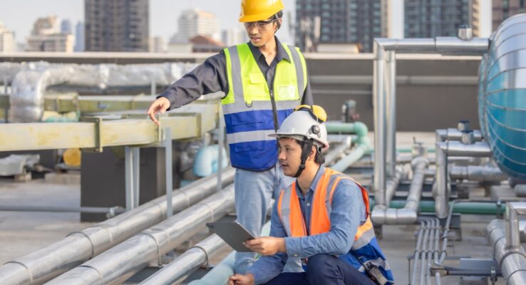 How Maintenance Enhances Property Value for Landlords 1 HVAC Engineer Coaching a Technician on Site During an Urban Maintenance Project