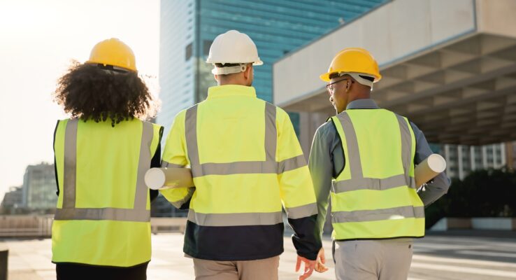 Why One Provider for Construction, Rental, and Maintenance Makes Sense 1 People, back and architect team walking in city for construction, maintenance or building on site.