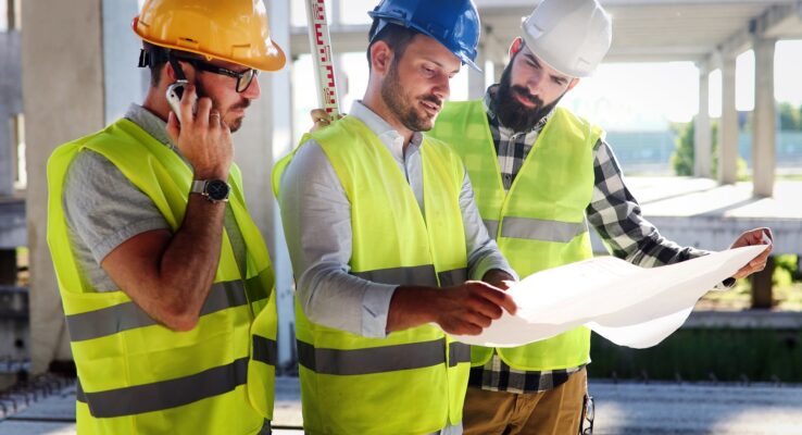 Architect consult engineer on modern construction site